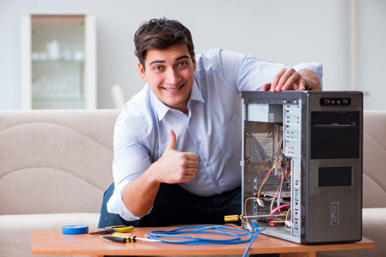 homem caucasiano sorridente mexendo em CPU ilustra artigo sobre salário de um técnico em TI